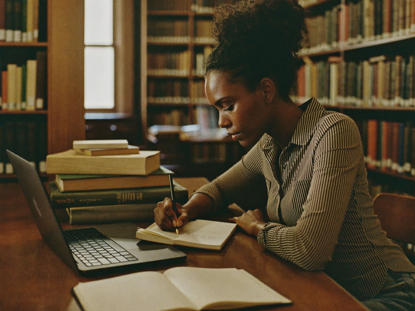 A woman studying at a library table