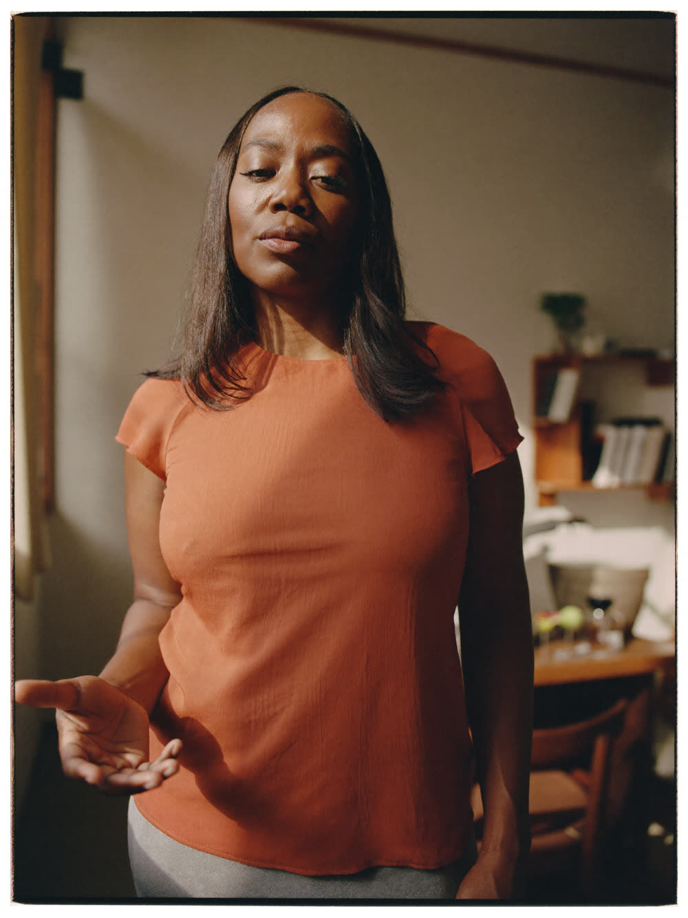 A woman standing in her sunlit textile workshop
